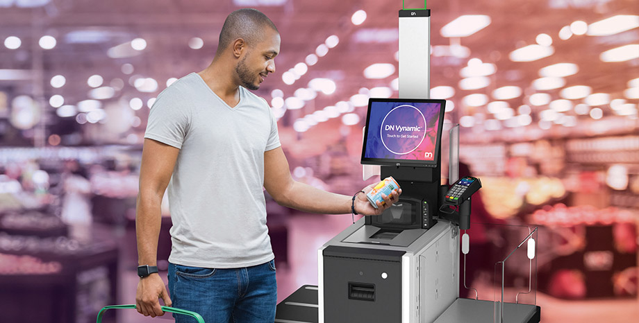 A man checks out at a store kiosk using a self-service retail solution