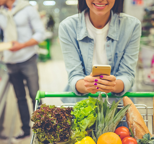 woman on smart phone in a grocery store