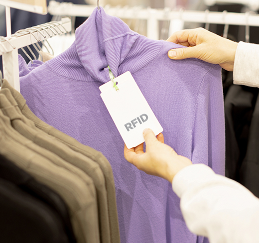 hands grabbing sweatshirt in retail store