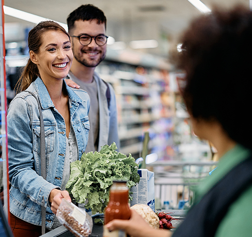 man and woman purchasing items at checkout