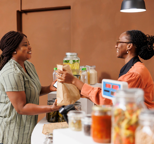 coffee shop transaction exchange between 2 women