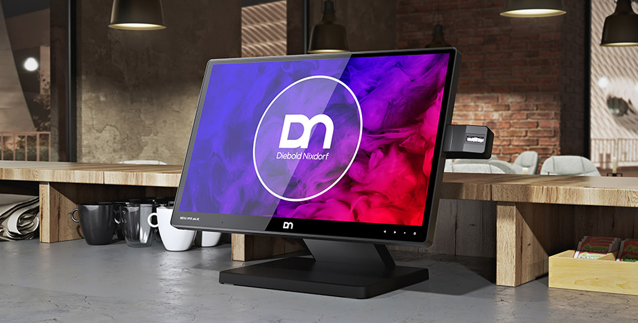 Computer monitor sits on a countertop at a coffee shop with the DN Series BEETLE retail POS systems logo on the screen
